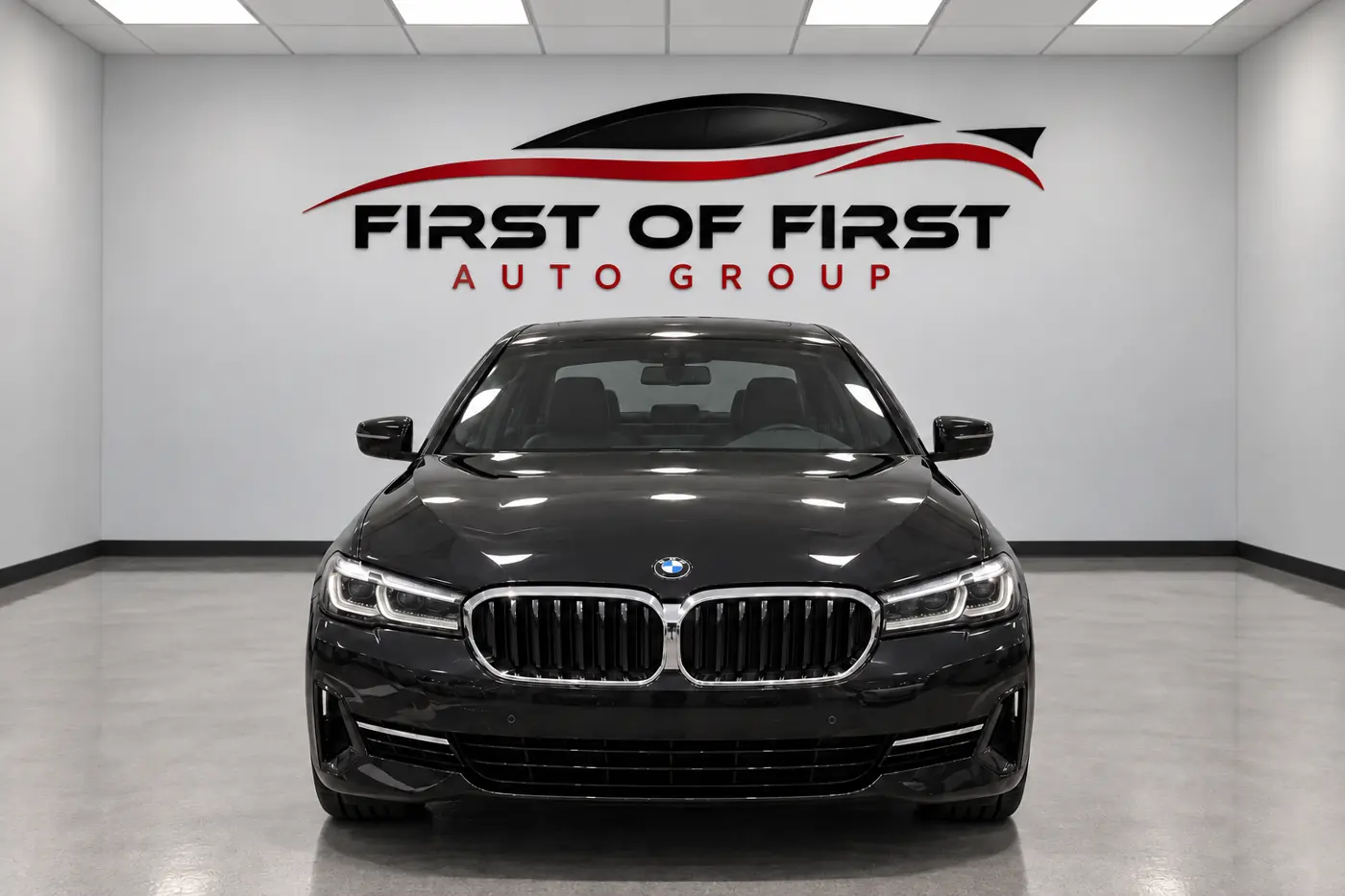 Black BMW 5 Series in the First of First Auto Group showroom